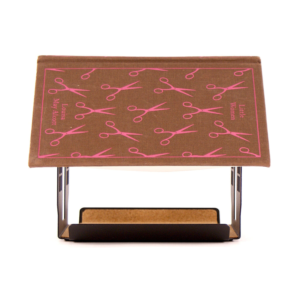 Brown book on top of a house shaped book rest.