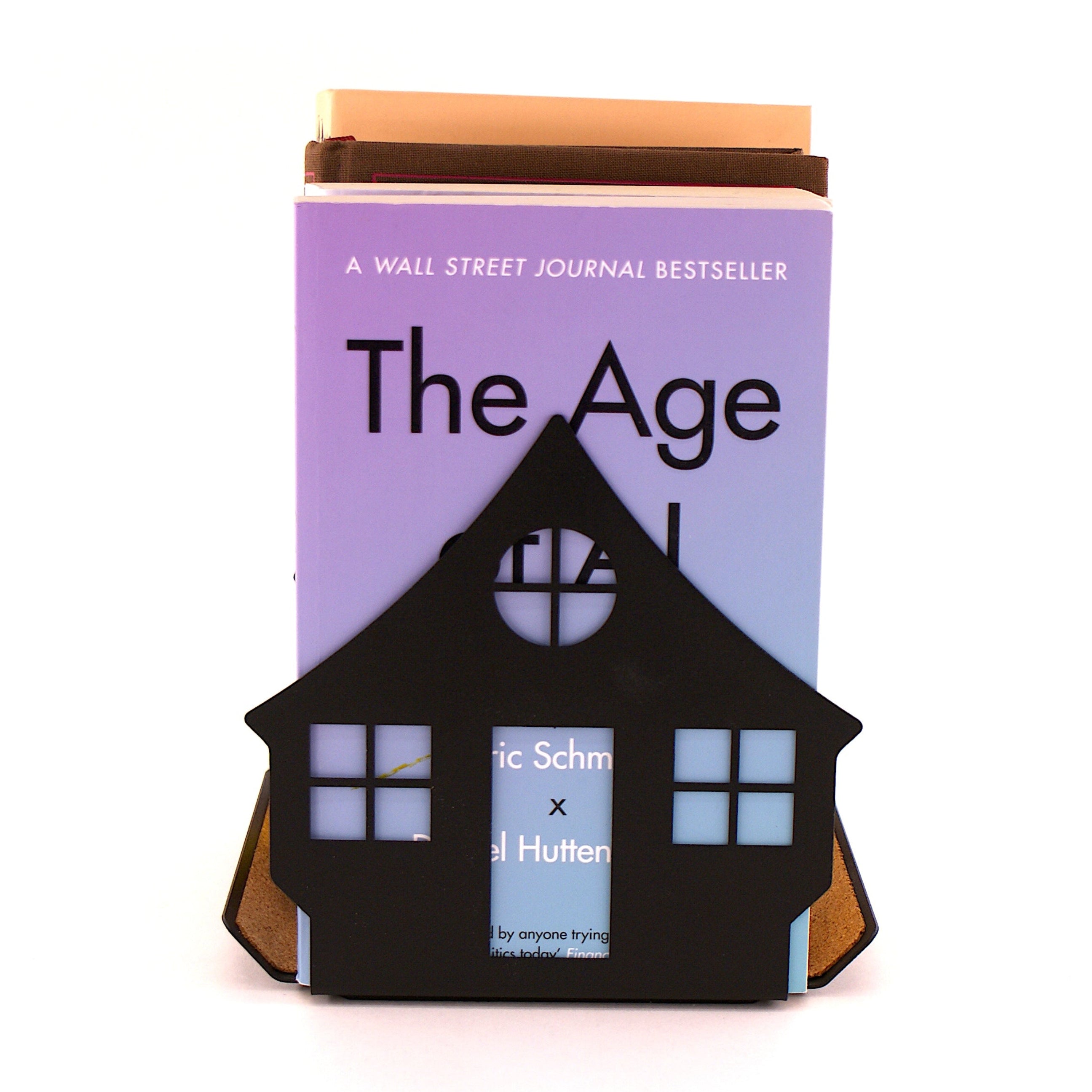 Books standing in a house shaped book rest being used as a book stand
